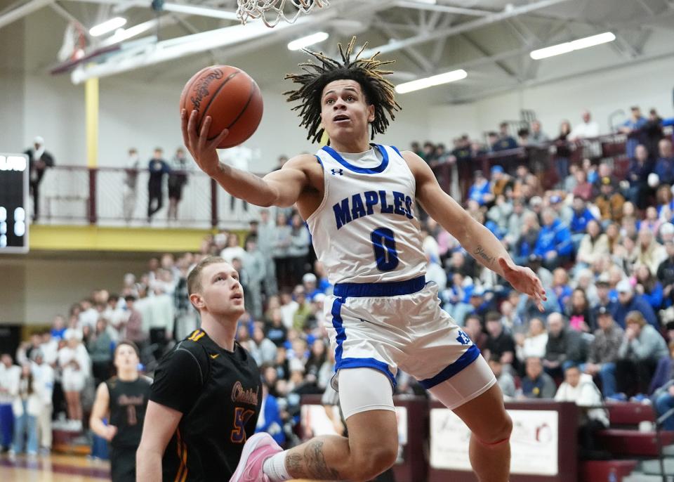 Adrian's Stevie Elam goes up for a layup during a Division 2 district final at Parma Western.