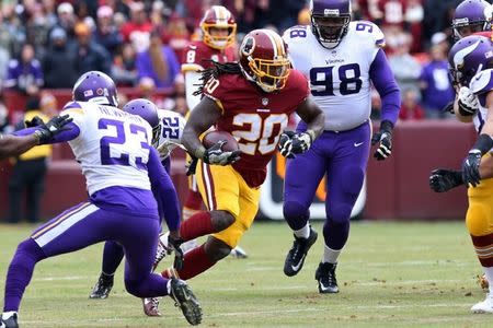 Nov 12, 2017; Landover, MD, USA; Washington Redskins running back Rob Kelley (20) carries the ball as Minnesota Vikings free safety Harrison Smith (22) and Vikings cornerback Terence Newman (23) defend in the first quarter at FedEx Field. Geoff Burke-USA TODAY Sports