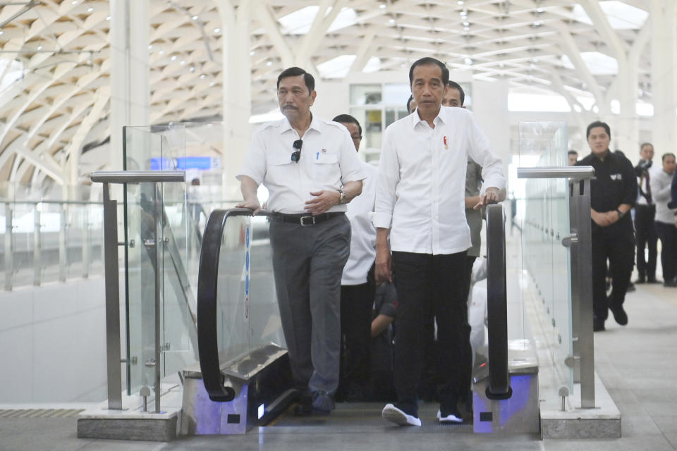 Indonesian President Joko Widodo, right, walks with Coordinating Minister for Maritime and Investment Affairs Luhut Binsar Panjaitan, left, at Halim station in Jakarta, Indonesia, Wednesday, Sept. 13, 2023. Indonesia's President took a test ride Wednesday on Southeast Asia's first high-speed railway as a key project under China's Belt and Road infrastructure initiative. (Akbar Nugroho Gumay/Pool Photo via AP)