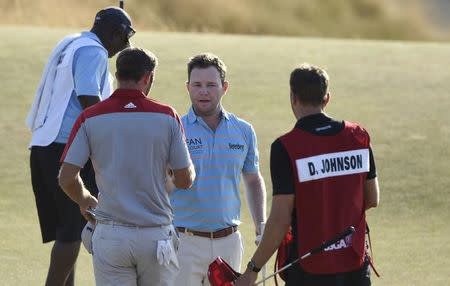 Jun 20, 2015; University Place, WA, USA; Branden Grace (middle) shakes hands with Dustin Johnson after completing the third round of the 2015 U.S. Open golf tournament at Chambers Bay. Mandatory Credit: Kyle Terada-USA TODAY Sports