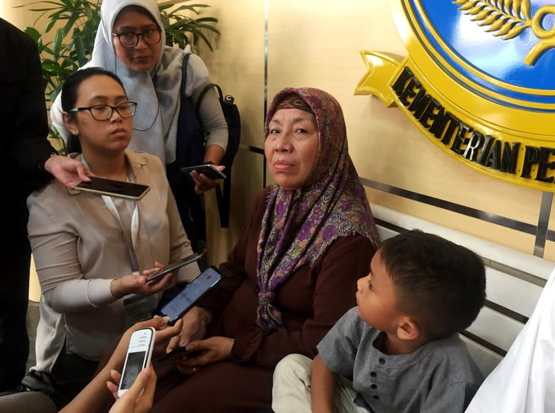 A family member of one of the flight attendants aboard the crashed Lion Air flight JT610 speaks to the media in the lobby of the Transport Ministry ahead of the briefing to the families of victims on the final report on the crash in Jakarta