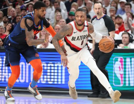 Apr 23, 2019; Portland, OR, USA; Portland Trail Blazers guard Damian Lillard (0) drives on Oklahoma City Thunder forward Paul George (13) in the second half of game five of the first round of the 2019 NBA Playoffs at Moda Center. Mandatory Credit: Jaime Valdez-USA TODAY Sports