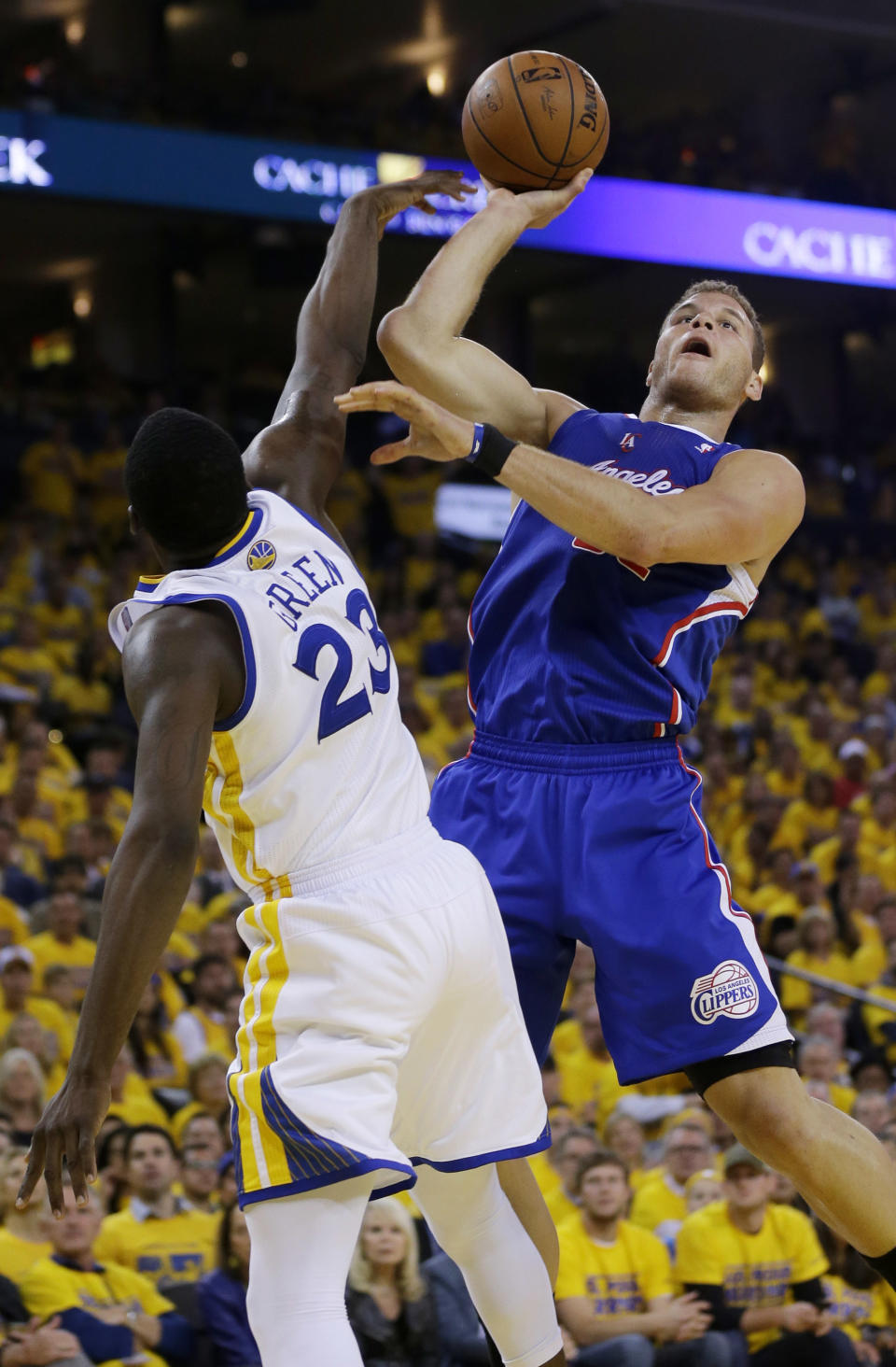 Los Angeles Clippers' Blake Griffin, right, goes up for a shot next to Golden State Warriors' Draymond Green during the first half in Game 4 of an opening-round NBA basketball playoff series on Sunday, April 27, 2014, in Oakland, Calif. (AP Photo/Marcio Jose Sanchez)