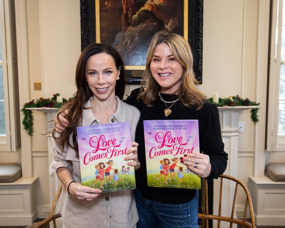 Former first daughters and twin sisters Barbara Pierce Bush, left, and Jenna Bush Hager, right, hold their new children's book, "Love Comes First," at the Louis T. Graves Memorial Public Library in Kennebunkport, Maine, on Saturday, Dec. 9, 2023.