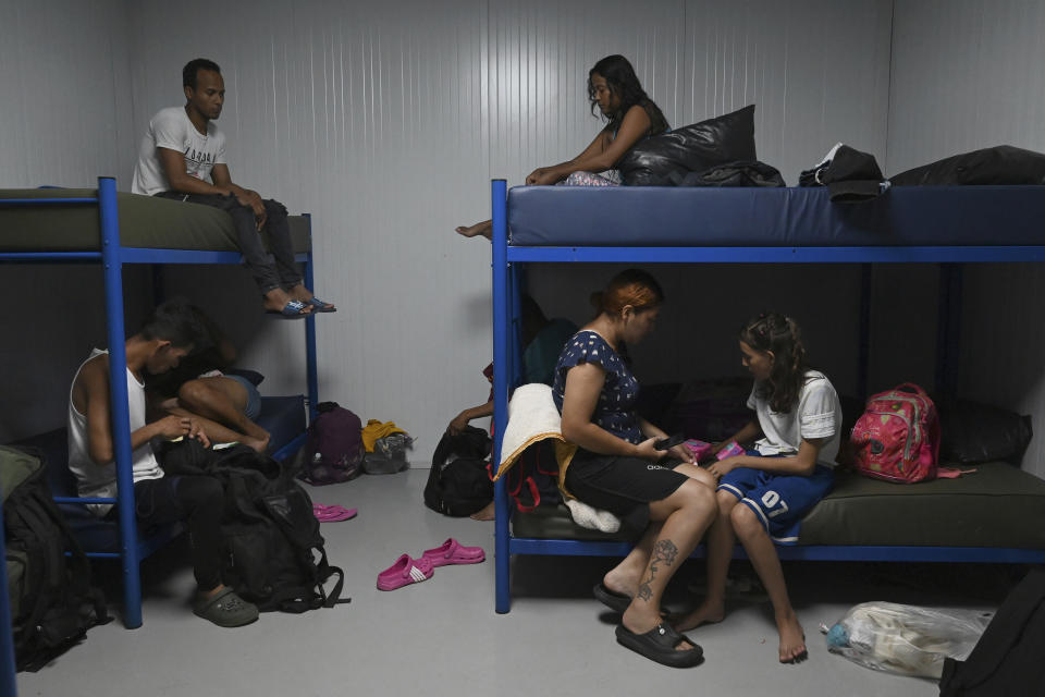 Migrants from Venezuela prepare to sleep at a Migrant Temporal Attention Center in Paso Canoas, Costa Rica, Monday, Oct. 16, 2023. Panama and Costa Rica launched a plan to quickly bus thousands of migrants through Panama to the Costa Rican border, as the countries continue to grapple with the increasing number of migrants. (AP Photo/Carlos Gonzalez)