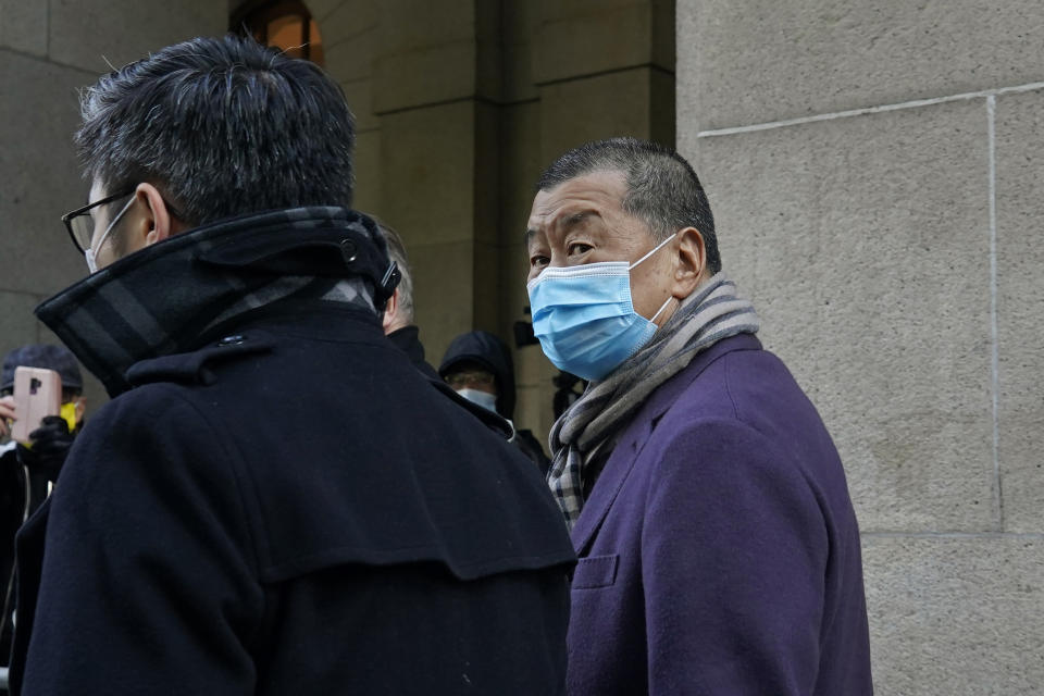 Hong Kong pro-democracy activist and media tycoon Jimmy Lai, right, leaves the Court of Final Appeal during a break in Hong Kong, Thursday, Dec. 31, 2020. Lai appeared in court Thursday as prosecutors asked the city's top judges to send him back to detention after he was granted bail last week on fraud and national security-related charges. (AP Photo/Kin Cheung)
