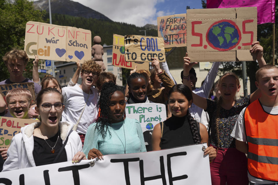 FILE - Climate activists Elizabeth Wathuti, of Kenya, Vanessa Nakate, of Uganda, and Helena Gualinga of Ecuador attend the climate protest alongside the World Economic Forum in Davos, Switzerland, May 26, 2022. Young climate activists from African nations have high demands but low expectations for the U.N. climate conference which begins Sunday, Nov. 6, in the Egyptian coastal resort of Sharm el-Sheikh. (AP Photo/Evgeniy Maloletka, File)