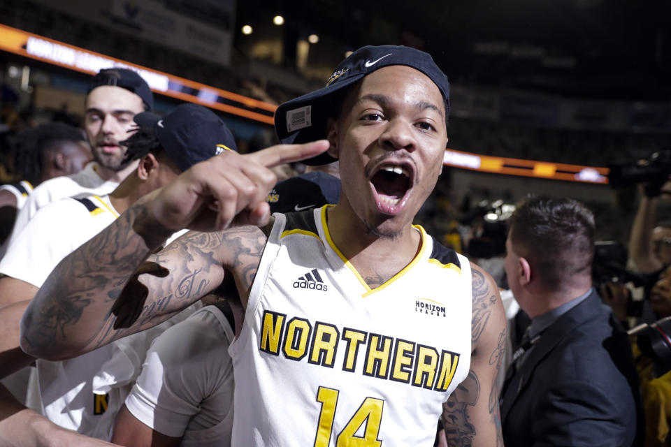 FILE- In this March 10, 2020, file photo, Northern Kentucky guard Karl Harris (14) celebrates following an NCAA college basketball game against Illinois Chicago in the Horizon League men's tournament championship in Indianapolis. Another dream, of playing in the NCAA Tournament, became a reality when Northern Kentucky clinched the Horizon League tournament title in March. Mere hours later, it was snatched away by a pandemic spiderwebbing across the globe. (AP Photo/Michael Conroy, File)