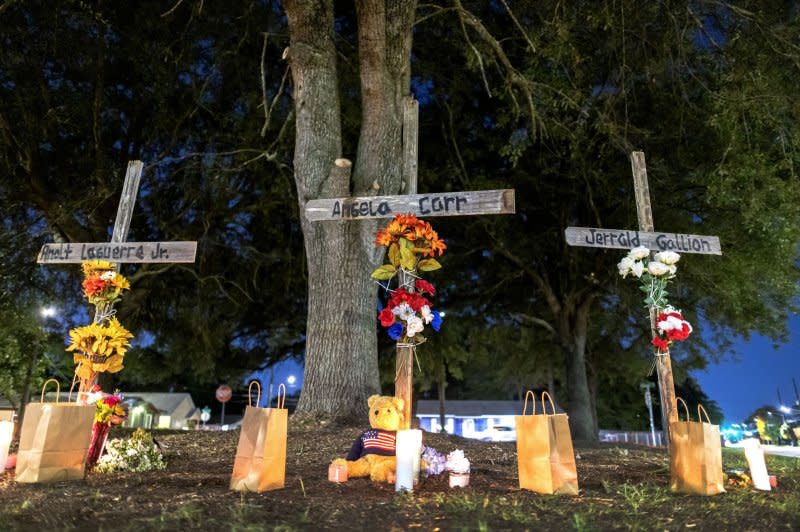 Crosses pay tribute to three people slain in a racially motivated mass shooting on Sunday in Jacksonville, Fla. Photo by EPA-EFE