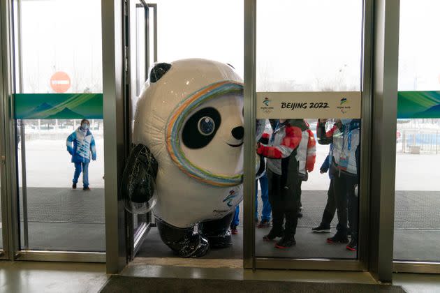 Bing Dwen Dwen, an inflated mascot of the 2022 Winter Olympics, tries to squeeze through the door of the main media center at at the games on Monday.  (Photo: Jae C. Hong / AP)