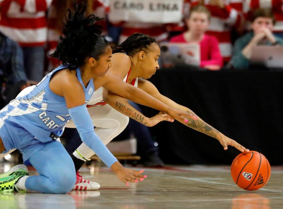 North Carolina’s Deja Kelly and N.C. State’s Aziaha James dive on the floor during the second half of the Wolfpack’s 63-59 win on Thursday, Feb. 1, 2024, at Reynolds Coliseum in Raleigh, N.C. Kaitlin McKeown/kmckeown@newsobserver.com