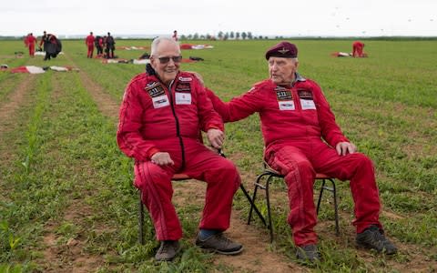 Veteran Harry Read, 95, (left) and Jock Hutton, 94, after completing their tandem parachute jump with the Red Devils - Credit: &nbsp;Jane Barlow/PA