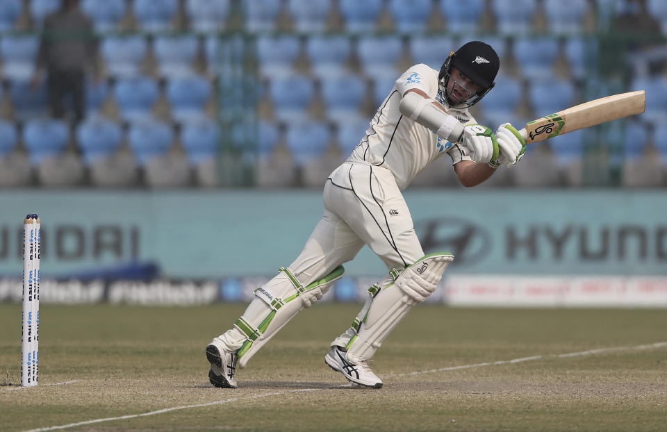 New Zealand's Tom Latham plays a shot during the day five of their first test cricket match with India in Kanpur, India, Monday, Nov. 29, 2021. (AP Photo/Altaf Qadri)