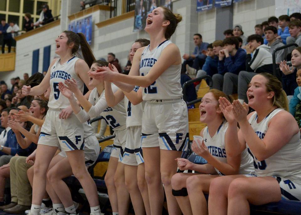 The Franklin High School Panthers girls basketball team hosted Braintree High School in a Round of 32 playoff game on March 4. Franklin won, 70-43. Pictured, players cheer on teammates at the end of the game. From left: senior Brigid Earley, senior Julia White, senior Jessica Pingeton, junior Katie Peterson.