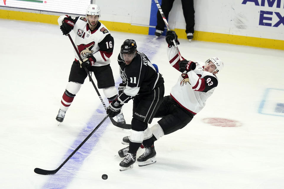 Los Angeles Kings center Anze Kopitar (11) collides with Arizona Coyotes' Lane Pederson, right, during the second period of an NHL hockey game Wednesday, April 7, 2021, in Los Angeles. (AP Photo/Marcio Jose Sanchez)