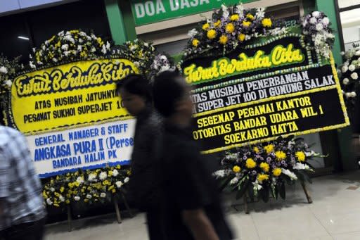 Floral condolence message boards line up the arrival entrance of Halim Perdanakusuma airport in Jakarta, on May 12, as bodies of the Sukhoi plane crash victims arrive in the Indonesian capital for identification