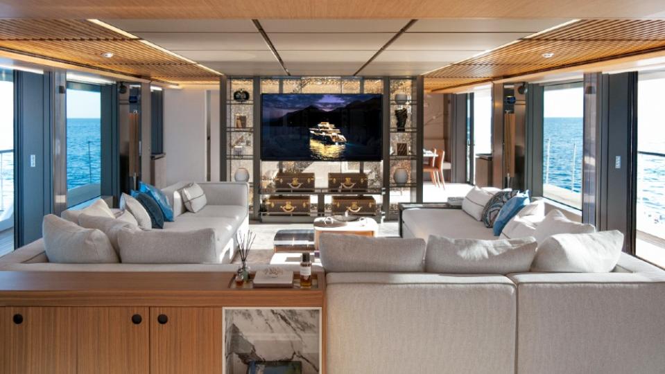 The main salon’s light decor, floor-to-ceiling windows and a see-through partition to the dining room are representative of the rest of the yacht. - Credit: Courtesy Pozitif Studio