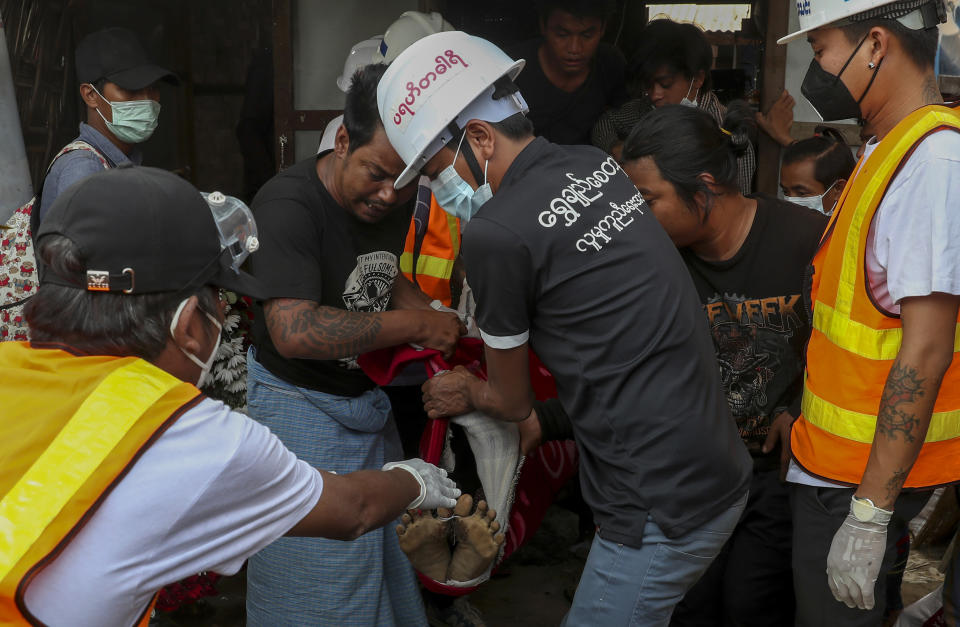 The body of Saw Pyae Naing is carried to a hearse in Mandalay, Myanmar, Sunday, March 14, 2021. Saw Pyae Naing, a 21-year old anti-coup protester, was shot and killed by Myanmar security forces during a demonstration on Saturday according to his family. (AP Photo)