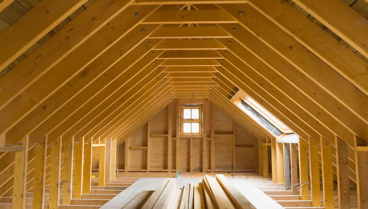 An unfinished attic with exposed wood beams