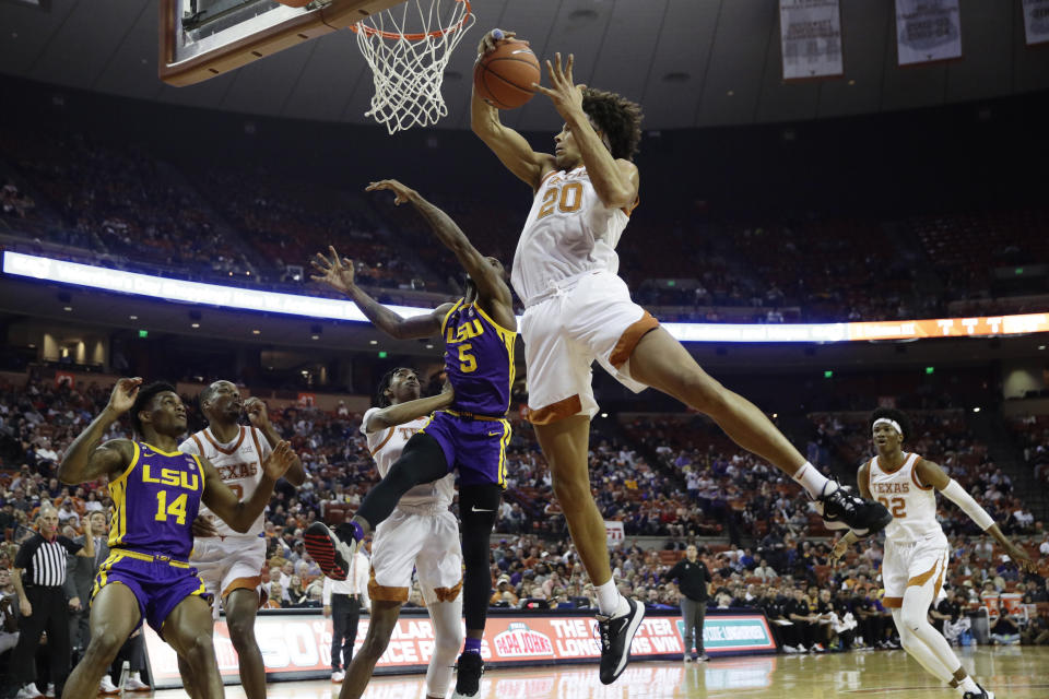 Texas forward Jericho Sims (20) pulls down a rebound over LSU forward Emmitt Williams (5) during the first half of an NCAA college basketball game, Saturday, Jan. 25, 2020, in Austin, Texas. (AP Photo/Eric Gay)