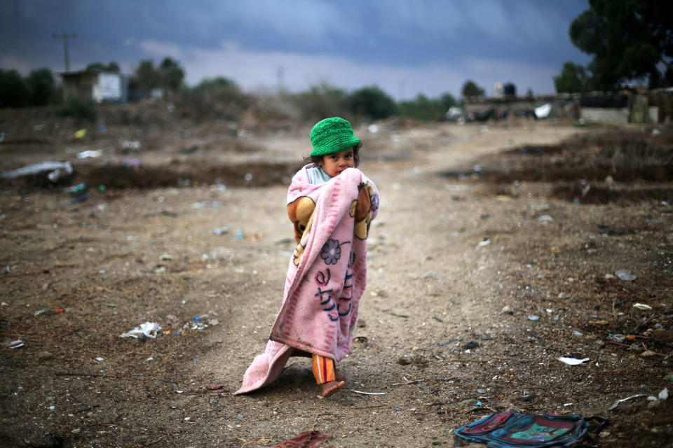 A Palestinian girl walks in Khan Younis, Gaza Strip