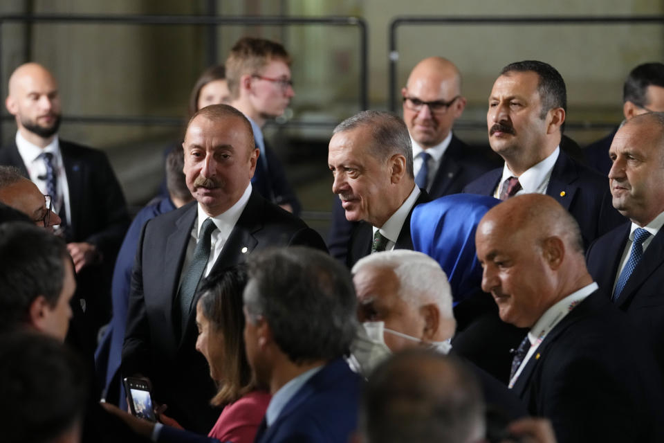 Turkey's President Recep Tayyip Erdogan, center right, speaks with Azerbaijan's President Ilham Aliyev, center left, after a group photo during a meeting of the European Political Community at Prague Castle in Prague, Czech Republic, Thursday, Oct 6, 2022. Leaders from around 44 countries are gathering Thursday to launch a "European Political Community" aimed at boosting security and economic prosperity across the continent, with Russia the one major European power not invited. (AP Photo/Petr David Josek)