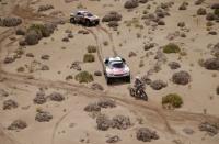 Dakar Rally - 2017 Paraguay-Bolivia-Argentina Dakar rally - 39th Dakar Edition - Fifth stage from Tupiza to Oruro, Bolivia 06/01/17. Gregory Morat of France rides his KTM followed by Stephane Peterhansel of France drives his Peugeot with his copilot Jean Paul Ottret and Cyril Despres of France drives his Peugeot with his copilot David Costera. REUTERS/Ricardo Moraes