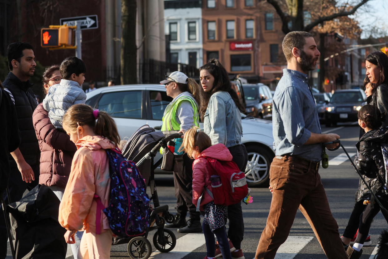 Children and parents are seen walking to school in Brooklyn, N.Y.