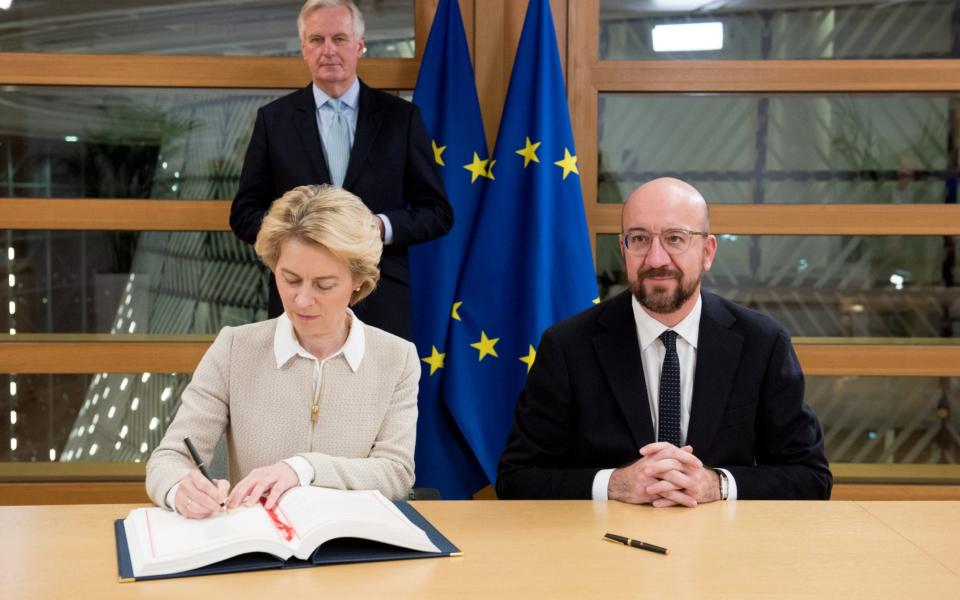 President of the European Council, Charles Michel (right) and European Commission President Ursula von der Leyen signing the Agreement on the Withdrawal of the UK from the EU, watched by EU Chief Brexit Negotiator Michel Barnier - European Commission/PA