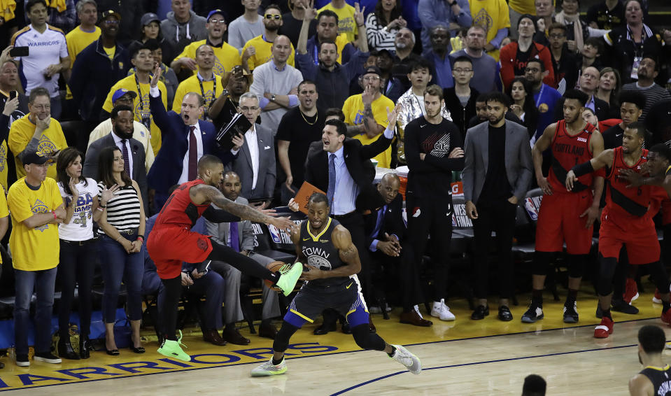 Golden State Warriors' Andre Iguodala, center, strips the ball from Portland Trail Blazers' Damian Lillard during the final seconds of Game 2 of the NBA basketball playoffs Western Conference finals Thursday, May 16, 2019, in Oakland, Calif. (AP Photo/Ben Margot)