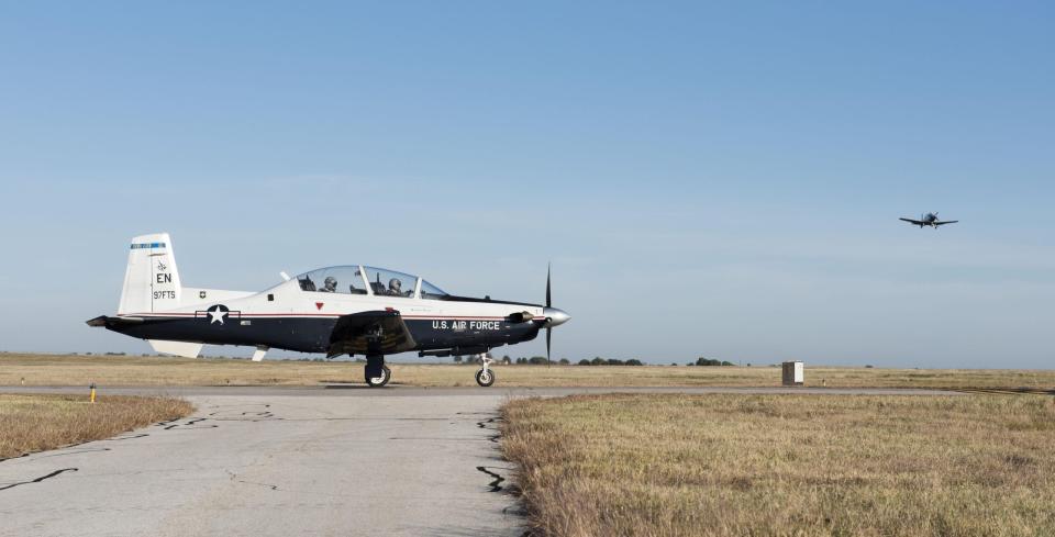 A T-6A Texan II waits for another T-6A to pass before taxing onto the runway November 1, 2017, at Sheppard Air Force Base, Texas.<em> U.S. Air Force photo by Christopher Carranza</em>