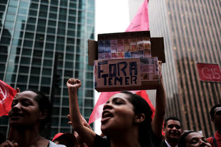 Members of Brazil's Homeless Workers' Movement (MTST) shout slogans holding a placard reading "Out Temer" during a vote on whether the Congress allows charges against President Michel Temer to be sent to the Supreme Court for trial, in Sao Paulo, Brazil October 25, 2017. REUTERS/Nacho Doce