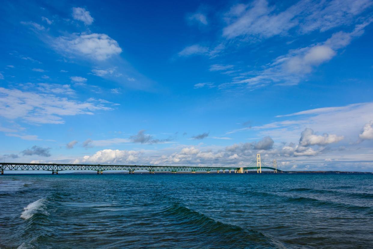 Mackinac Bridge in Upper Peninsula of Michigan in background with Lake Michigan and waves in the foreground
