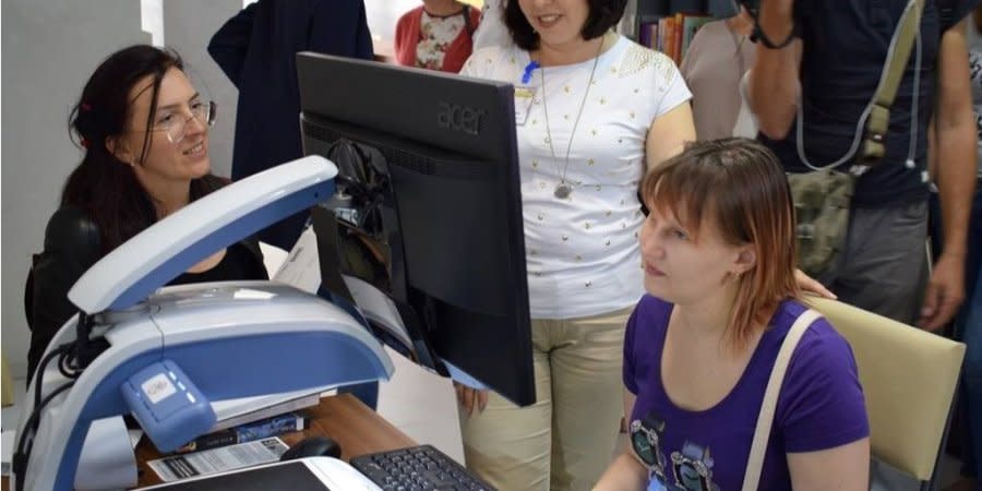 Daria Korzhavina (right, sitting at computer) tests out a website adapted for the visually impaired.