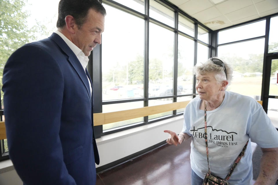 Republican state Sen. Chris McDaniel, left, a candidate in the party's lieutenant governor primary, speaks with a voter prior to him voting at his Ellisville, Miss., precinct, Tuesday, Aug. 8, 2023. McDaniel faces incumbent Lt. Gov. Delbert Hosemann who is seeking reelection, and a political unknown. (AP Photo/Rogelio V. Solis)