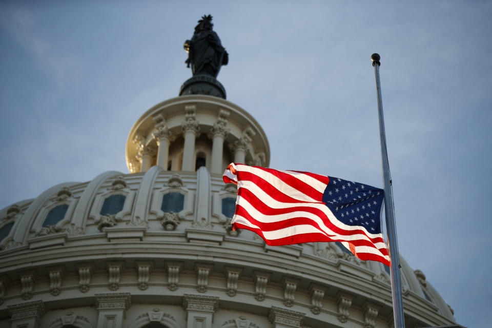 An American flag flies at half-staff at the U.S. Capitol in Washington on Monday, following the death of former President George H.W. Bush. (Photo: Bloomberg via Getty Images)