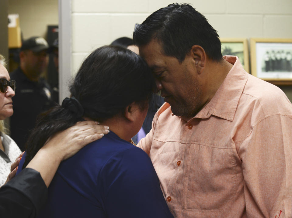 The widow of slain San Benito Police Officer Lt. Milton Resendez, who was killed in the line of duty, is embraced during a San Benito Police Department press conference Wednesday, Oct 18, 2023 in San Benito, Texas. (Miguel Roberts/The Brownsville Herald via AP)