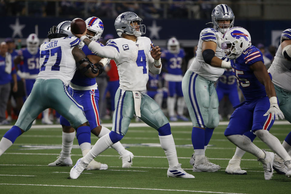 Dallas Cowboys quarterback Dak Prescott (4) throws a pass under pressure from Buffalo Bills defensive end Jerry Hughes (55) in the second half of an NFL football game in Arlington, Texas, Thursday, Nov. 28, 2019. (AP Photo/Ron Jenkins)