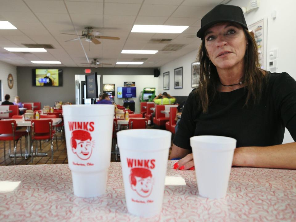 Lisa Houck is one of the co-owners of Wink's Drive-In, which charges for tap water to help cover the cost of the Barberton Restaurant's logo cups.
