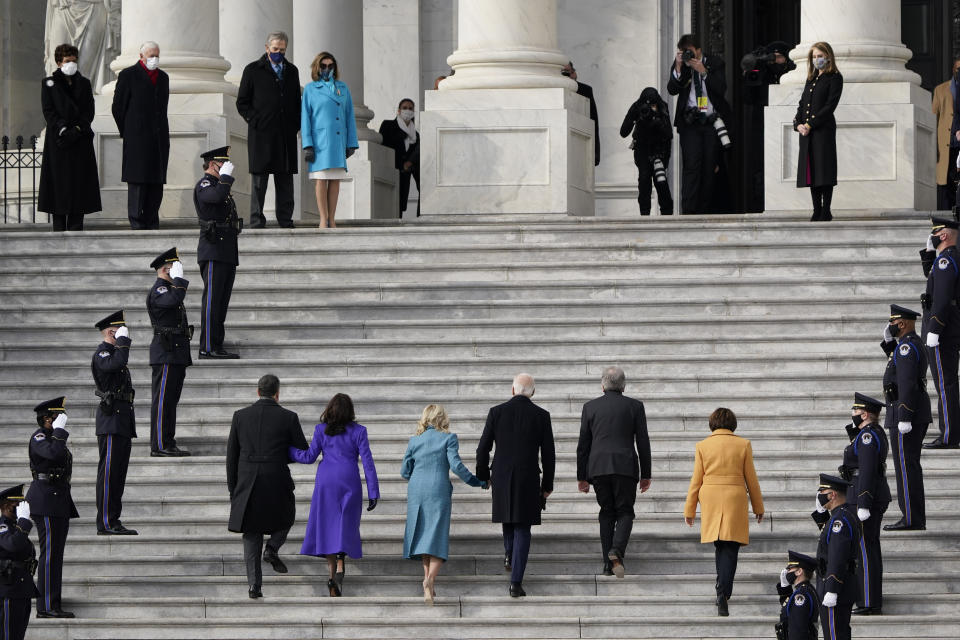 President-elect Joe Biden, his wife Jill Biden and Vice President-elect Kamala Harris and her husband Doug Emhoff arrive at the steps of the U.S. Capitol for the start of the official inauguration ceremonies, in Washington, Wednesday, Jan. 20, 2021. Speaker of the House, Nancy Pelosi waits at left. (AP Photo/J. Scott Applewhite)