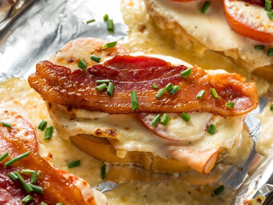 Hot Brown sandwich with bacon chicken and cream sauce in foil wrapper