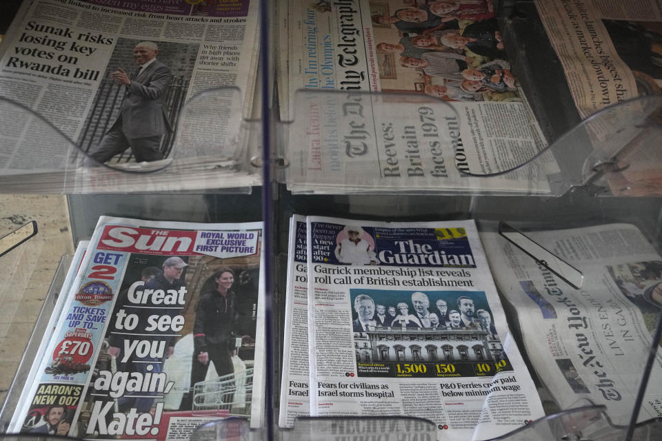 Newspapers on display for sale in London, Tuesday, March 19, 2024. A British newspaper says Prince William and his wife Catherine have been filmed at a farm shop near their Windsor home. It's the first reported footage of Kate since she had abdominal surgery for an unspecified condition two months ago. The Sun published a short clip late Monday that appeared to show the couple smiling as they walked together, carrying shopping bags. It said the footage was taken on Saturday. (AP Photo/Kirsty Wigglesworth)