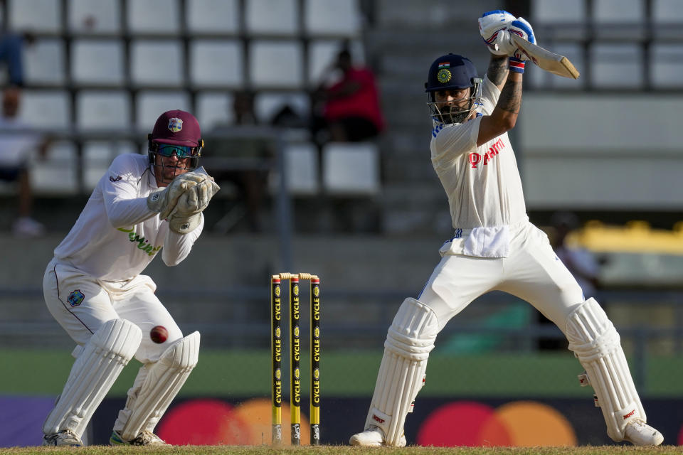 India's Virat Kohli plays a shot from the bowling of West Indies' Jomel Warrican under the look of keeper Joshua Da Silva on day two of their first cricket Test match at Windsor Park in Roseau, Dominica, Thursday, July 13, 2023. (AP Photo/Ricardo Mazalan)