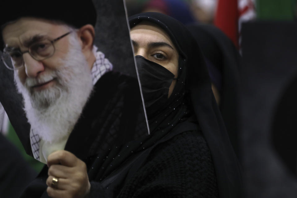 An Iranian woman holds a poster of the Supreme Leader Ayatollah Ali Khamenei during an election campaign rally ahead of the March 1 parliamentary elections, in Tehran, Iran, Tuesday, Feb. 27, 2024. (AP Photo/Vahid Salemi)