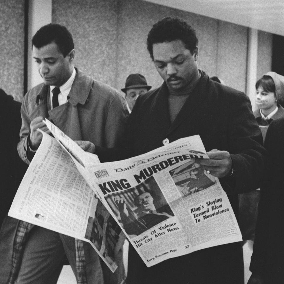 <p>Jesse Jackson, in Chicago, holds a copy of the Daily Defender, April 5, 1968. (Photo: Robert Abbott Sengstacke/Getty Images) </p>