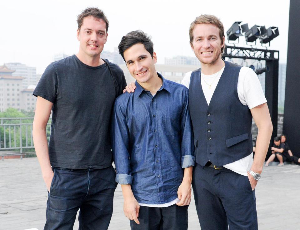 This June 2013 photo released by the Council of Fashion Designers of America (CFDA) shows, Rag & Bone designers Marcus Wainwright, left, and David Neville, right, with Proenza Schouler designer Lazaro Hernandez during preparations for a fashion show by New York-based designers in Beijing, China. Rag & Bone, Marchesa and Proenza Schouler, among the top in their class of cool, youngish New York-based fashion houses, took a field trip to China recently to introduce themselves to Chinese consumers and to bring home a better understanding of their needs. (AP Photo/Council of Fashion Designers of America, Neil Rasmus)