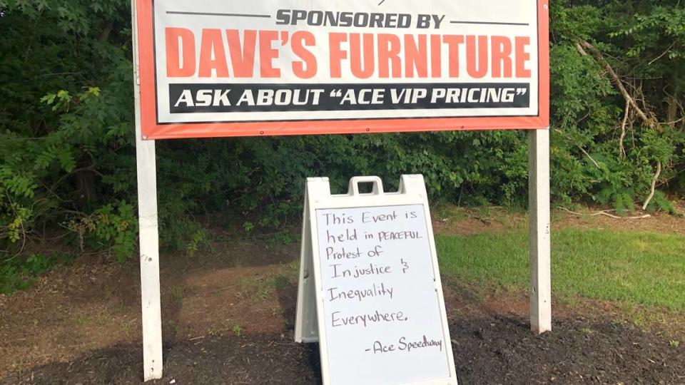 A sign outside Ace Speedway says “This Event is held in Peaceful Protest of Injustice and Inequality Everywhere. -- Ace Speedway” 