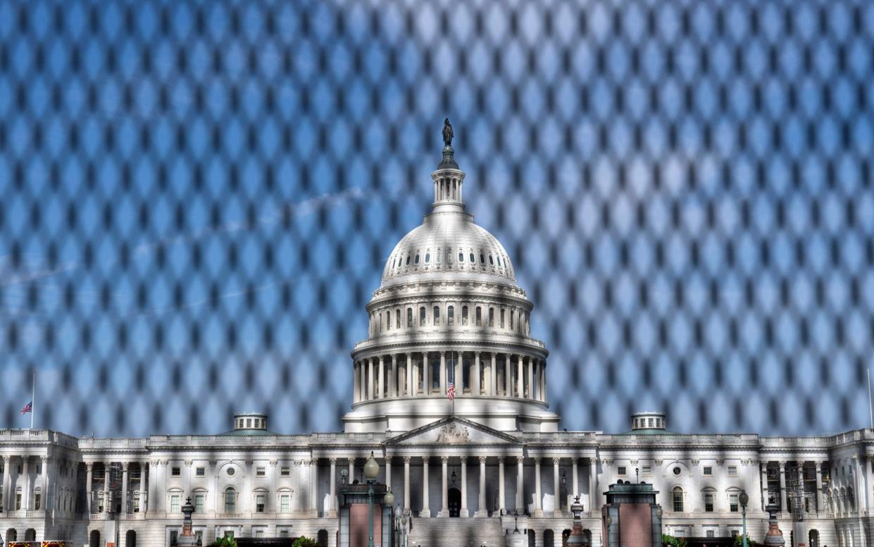 The US Capitol is seen behind a security fence as Israel's prime minister Benjamin Netanyahu  visits