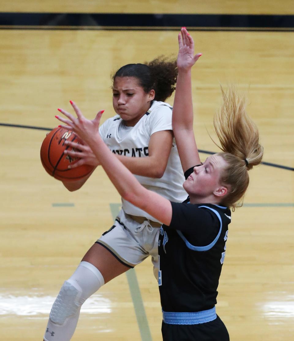 Whitefield Academy's Noel Smith (3) grabs a rebound over Mercy Academy's Emma Barnett (34) during their game at the Whitefield Academy gymnasium in Louisville, Ky. on Jan. 4, 2022.