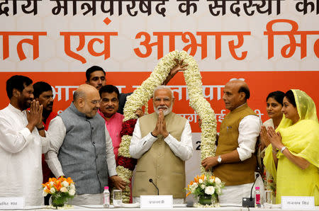 FILE PHOTO: Prime Minister Narendra Modi gestures as he is presented with a garland during a thanksgiving ceremony by Bharatiya Janata Party (BJP) leaders to its allies at the party headquarters in New Delhi, India, May 21, 2019. REUTERS/Anushree Fadnavis/File Photo
